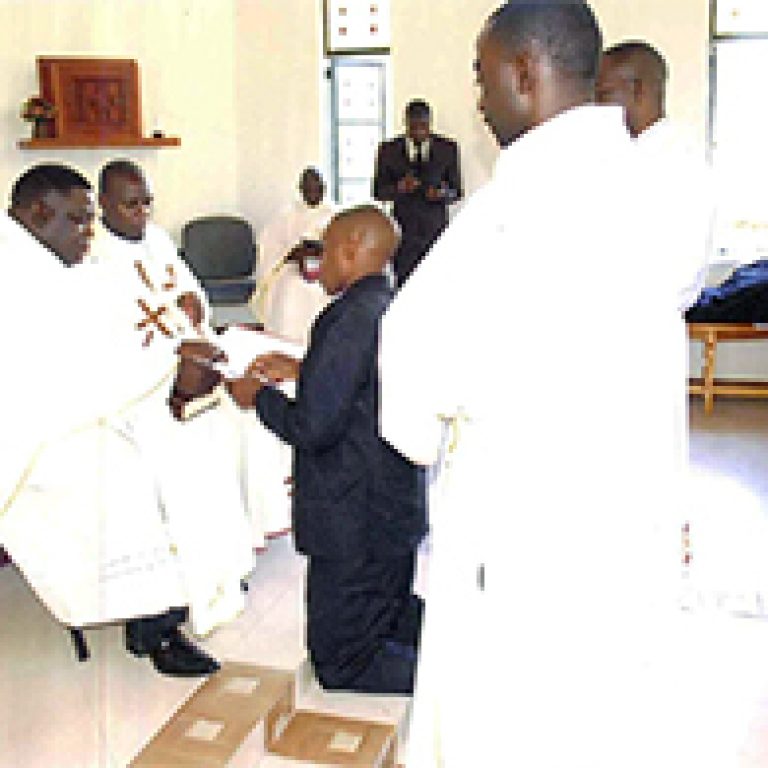 2._novice_peter_qorro_making_his_first_profession_of_vows_before_fr._amani_website
