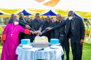Cake-ceremony-with-Bishop-Robert-Muhiirwa-the-Newly-Ordained-2500x1667